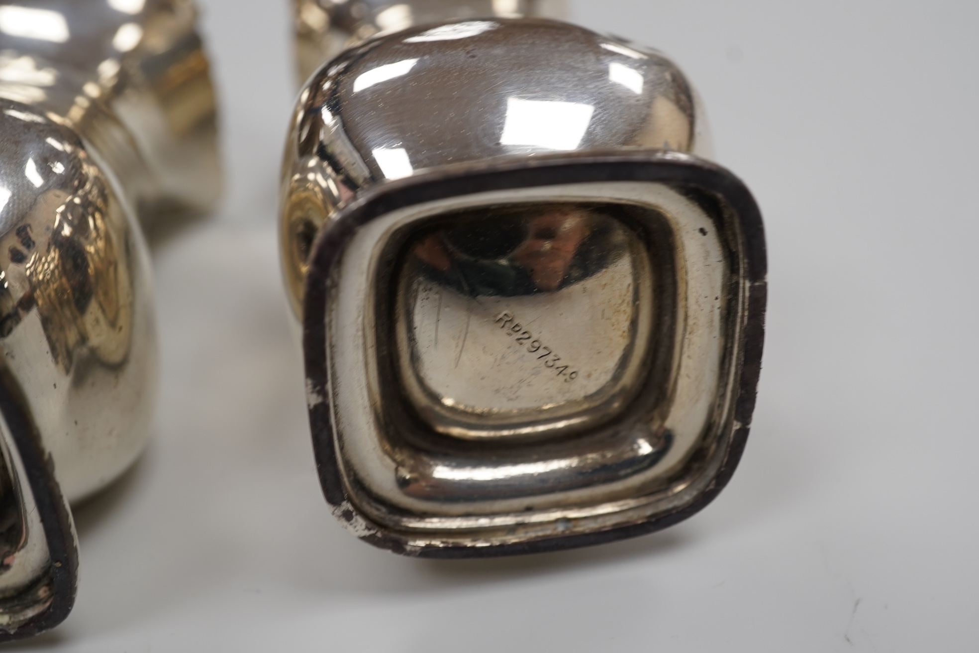 A George V silver drum mustard by Mappin & Webb, Birmingham, 1923, height 71mm, with associated spoon, together with a pair of George V silver pepperettes, Adie Brothers, Birmingham, 1923.